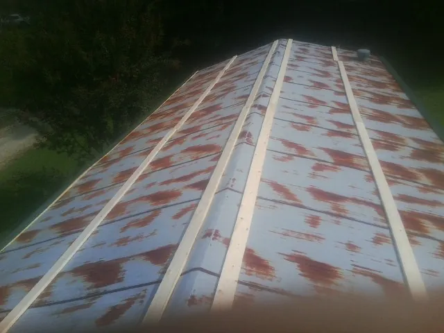 Rusted metal roof panels with new wood purlins before replacement — Storm Damage Roof Repair in Hallam by Roofing Brothers