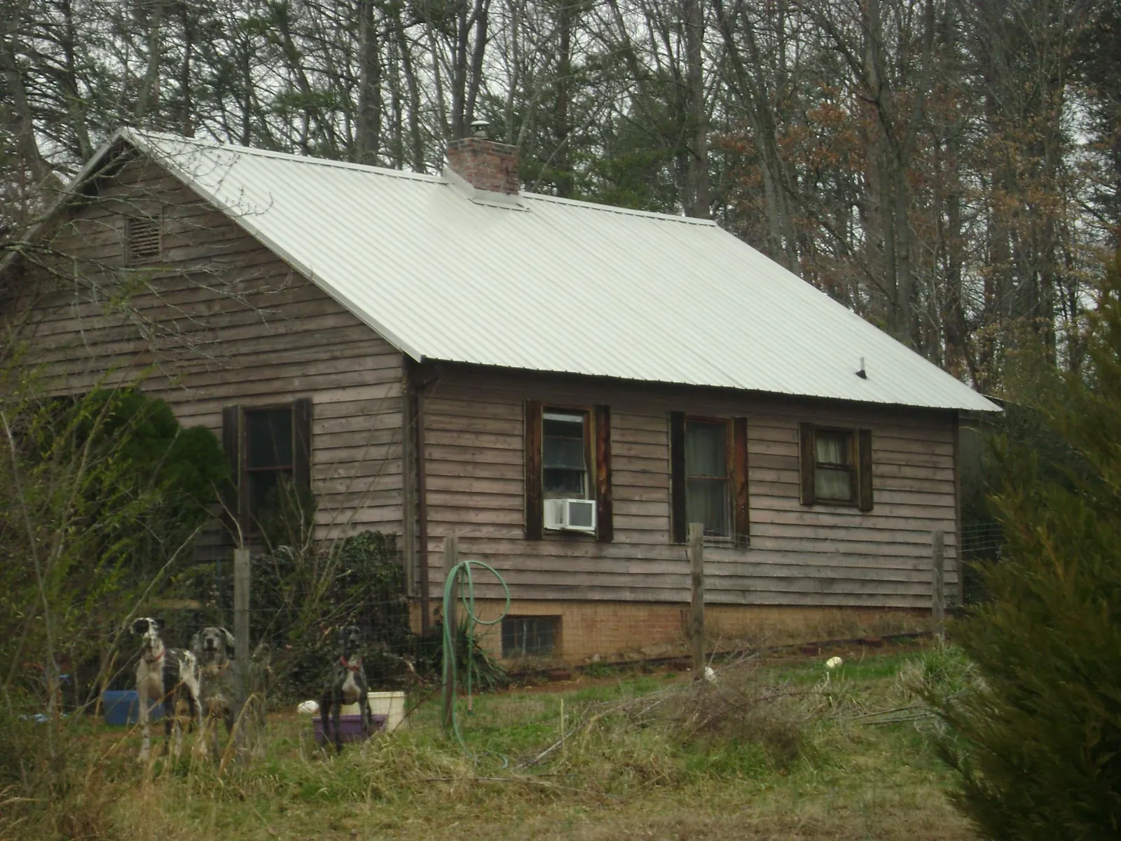 White metal roof on an old wood sided farmhouse, from a Metal Roof Installation job in Hallam